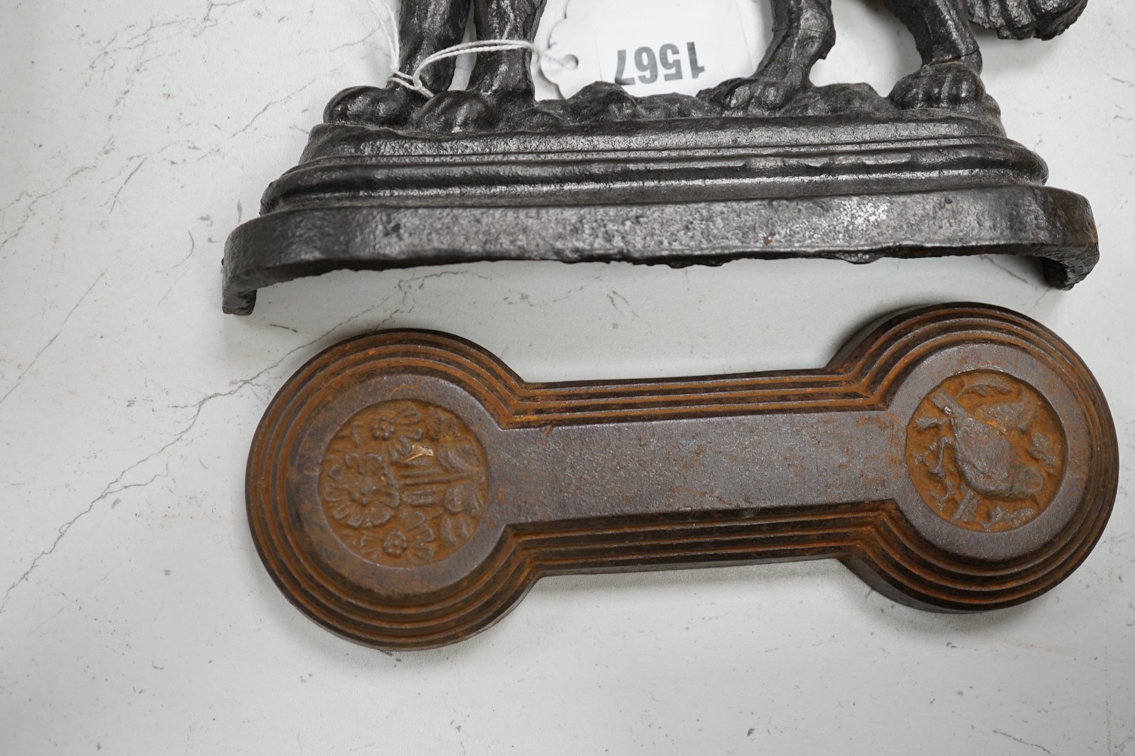 Two lion cast iron door stops, a St Bernard door stop and another, largest St Bernard 18cms high